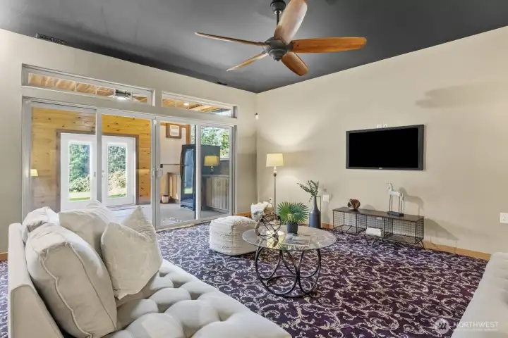 The sliding glass doors leads you to the covered patio with an outdoor kitchen.