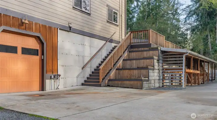 East side garage can fit 2 cars and has an upper level mezzanine for tools or storage.