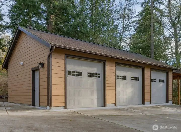 3 car garage and 1 covered carport with outlet. Dedicated 100 electrical panel to this garage.