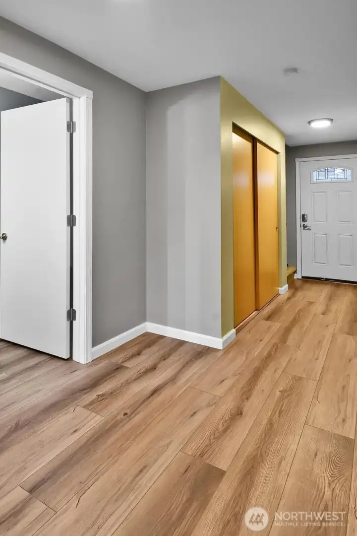 Entry hallway with newer luxury vinyl tile