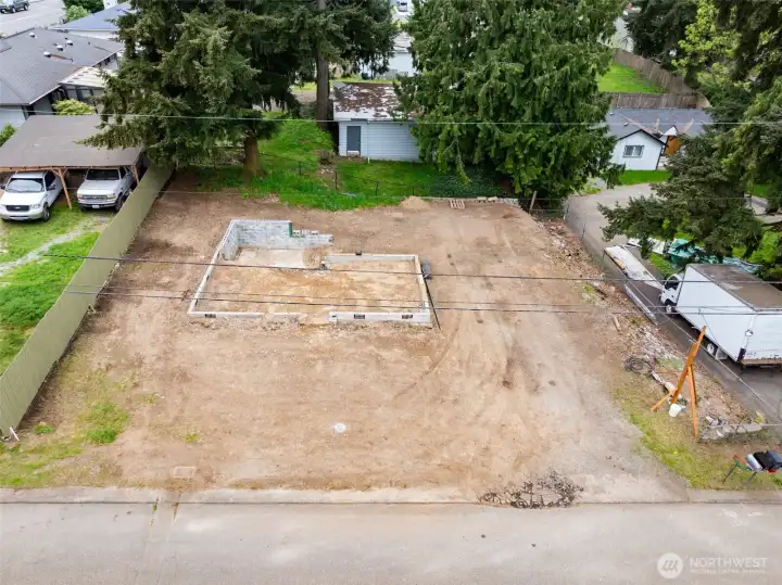 Aerial view showcasing full lot layout, access, and cleared building area. Ideal configuration for cottage or multi-unit development under UR4 zoning.