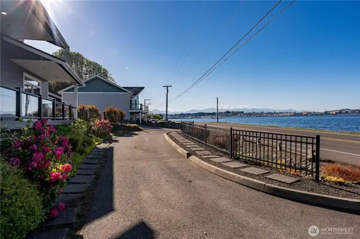 The property is full fenced for security with an iron gate entry. The garage is to the right with a covered entry to the main door.