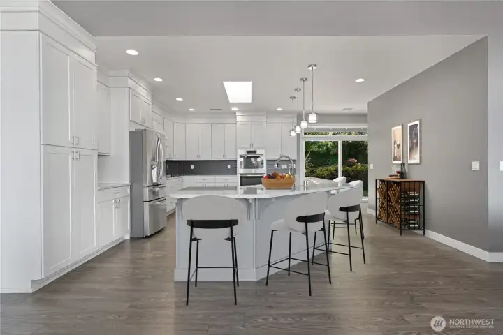 Enormous gourmet kitchen complete with a double oven, trash compactor and an oversized refrigerator.
