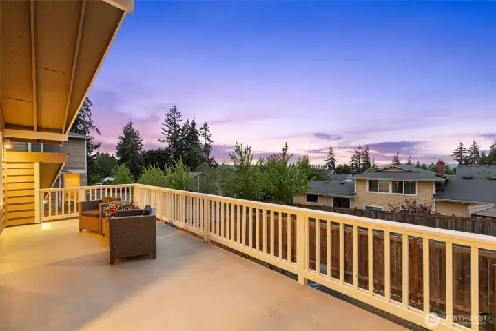 Elevated deck with sunset and territorial views, offering a quiet outdoor retreat above the fully fenced yard.