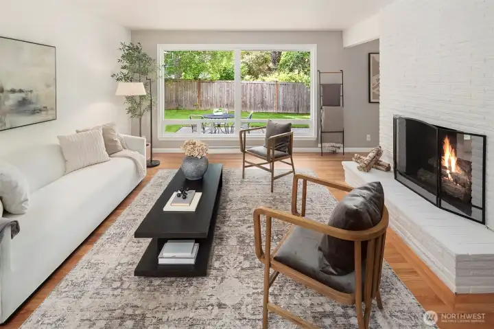 A large picture window frames this spacious living room