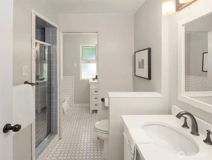 A smartly designed double bathroom with pocket door to merge and separate.