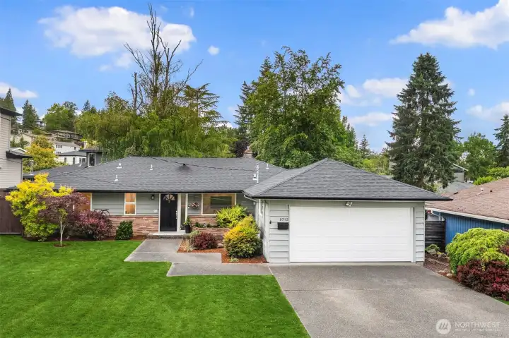Set back from the quiet street by a level mature lawn.