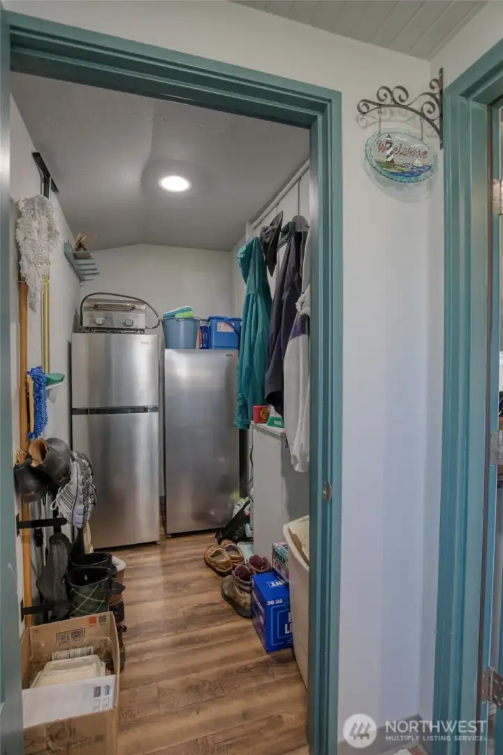 Off the entry is the covered mudroom with a lockable owners closet with storage and extra appliances.