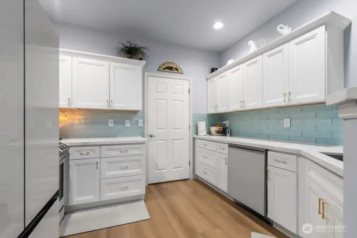 Fresh white cabinets accented with trendy gold pulls.
