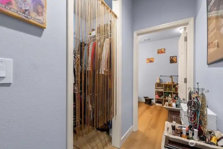 The walk-in closet is thoughtfully organized with tiered shelving