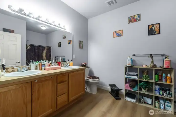 Experience ultimate convenience in this impressively oversized primary bath, featuring a massive double-sink vanity, a full bathtub, and an expansive layout designed for effortless mornings