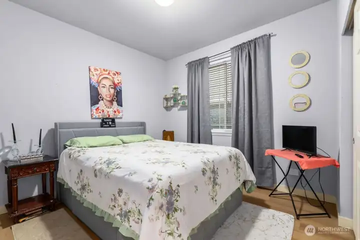This updated second bedroom offers a bright and inviting atmosphere with large windows that flood the space with natural light