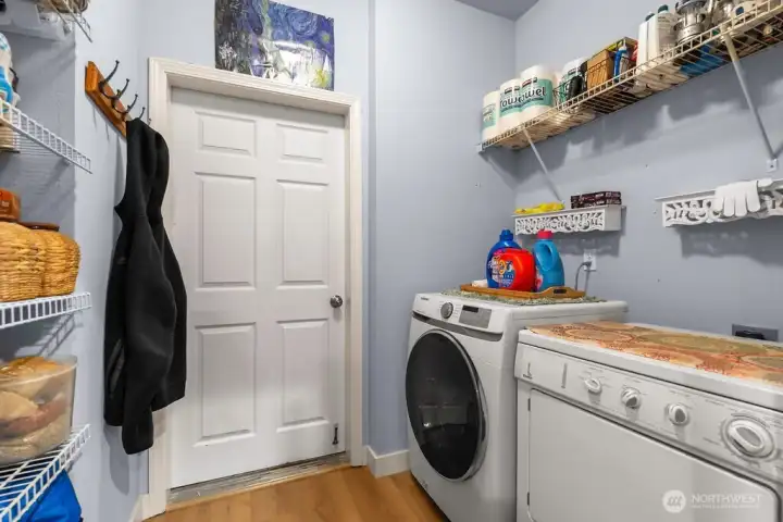 Maximize your daily productivity in this well-appointed laundry room, which serves as a highly functional mudroom with direct access to the attached garage