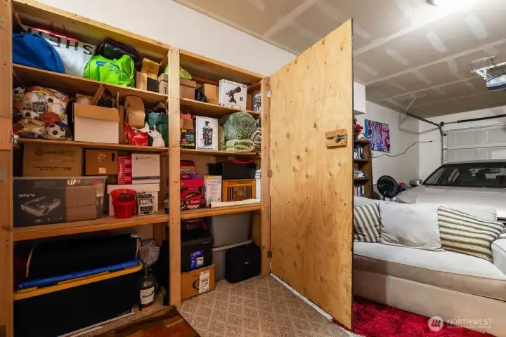 A floor-to-ceiling built-in unit offers multiple deep tiers to keep the garage floor clear and organized.