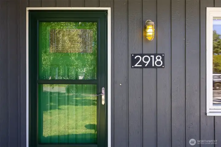 A bright green door welcomes you home.