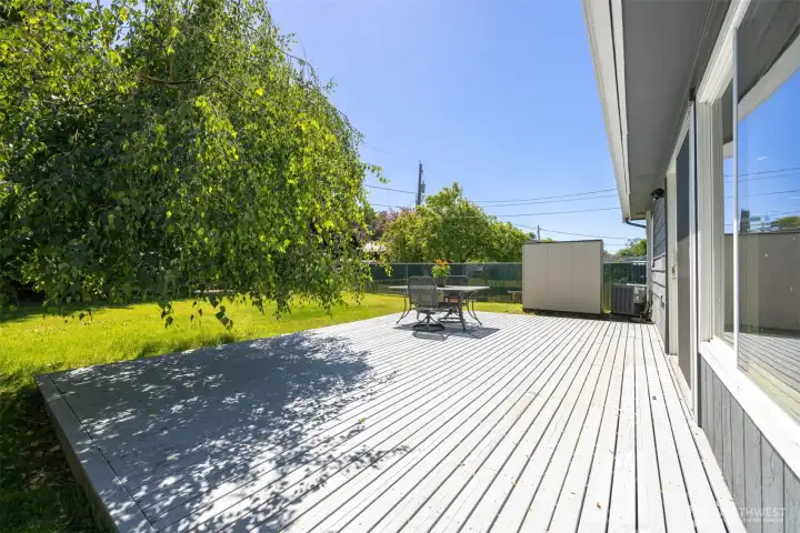 Deck accommodates a grill, table and additional lounging chairs.