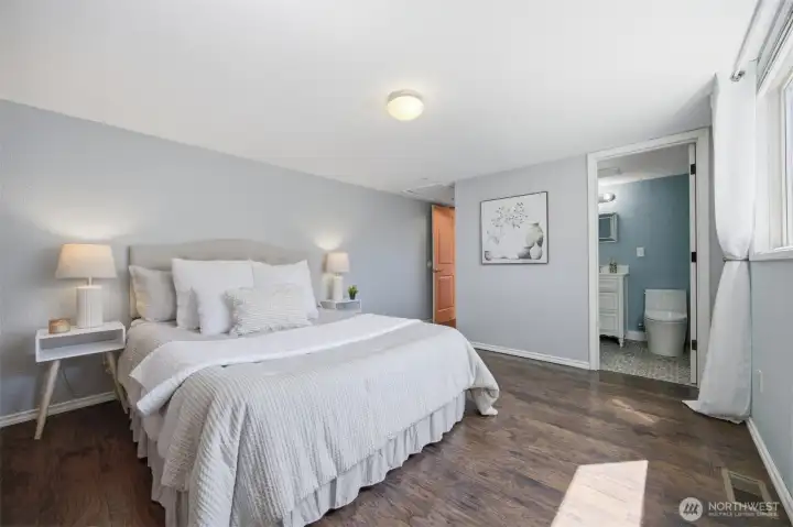 A nice pleasant primary bedroom with easy care for flooring.