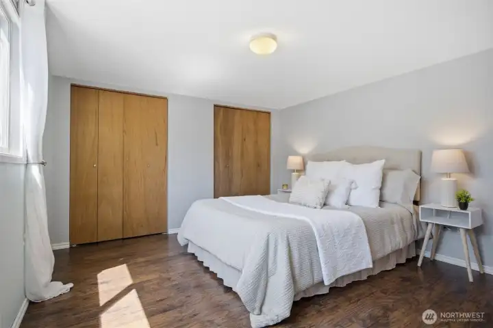 Primary bedroom is spacious and has pleasant light and double closet space.