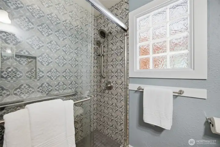 Main bathroom has a large tiled shower.  The window might confuse you at first, but there was an addition done by previous owners and they kept the window to allow natural light into this bathroom.