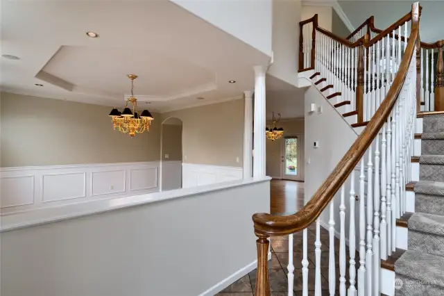 Dinning room features hardwood floors, custom wainscoting and a tray ceiling.