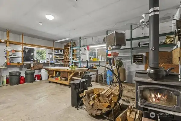 Very cool shop area with lots of shelving, wood heat, hot and cold water.  Check out the rolling table.