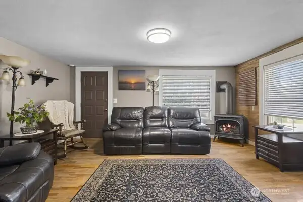 Another view of living room showing the cozy propane stove.