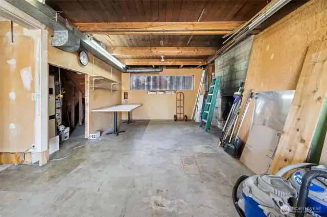 This could be a finished family or rec. room.  Wood burning fireplace and sliding glass door to backyard.  Finish the spaces on the lower level to build sweat equity: family room, laundry and 3/4 bath and possible 4th bedroom behind the garage.