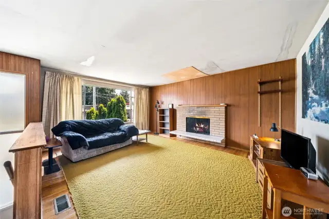 Original finishes from 1964 including hardwood floors throughout upstairs living, hallway, bedrooms and closets which have been protected by carpeting most of the years.  Wood burning fireplaces one on each level. 3 bedrooms and full bath upstairs.