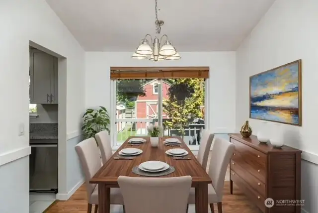 Virtually staged dining room looking out to huge landscaped yard.