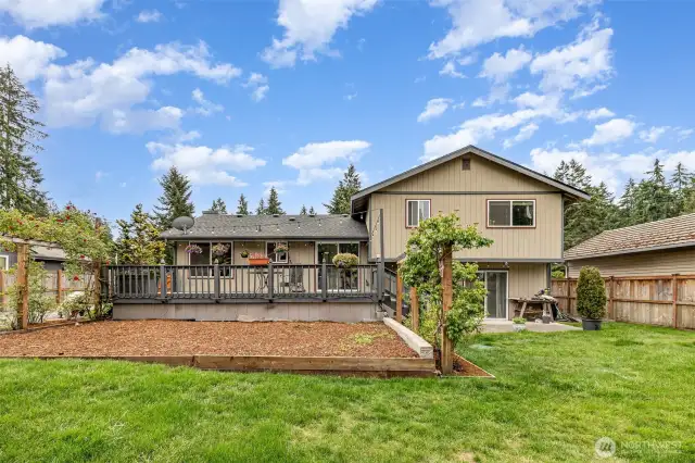 Huge, freshly landscaped yard with garden spaces.