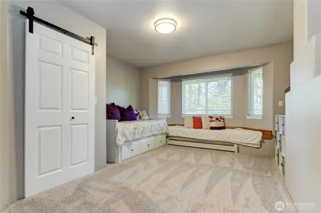 3rd bedroom with walk-in closet and built in window bench.