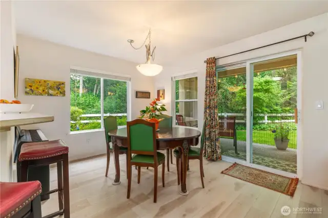 Dining area looking toward the patio and greenspace.