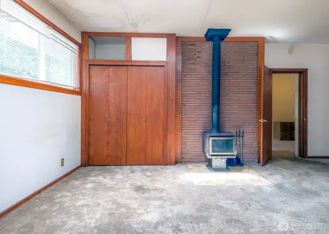 Wood Stove and roomy closets. There is abundant storage in this home! Open door leading to main living room.