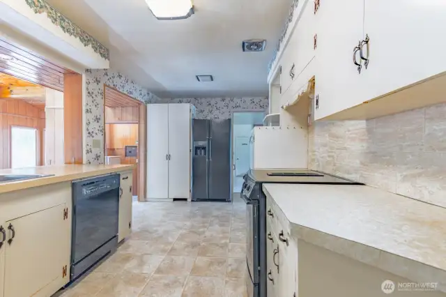 Main Kitchen adjacent to both the dining room and the sitting room/family room.