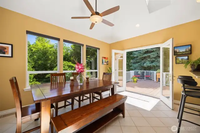 Newer addition of sun drenched dining room with vaulted ceilings and lots of windows and skylight. It feels like you are in a tree house. Patio door open to a spacious deck.