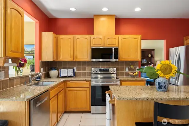 Well laid out kitchen has a new stove and a microwave
