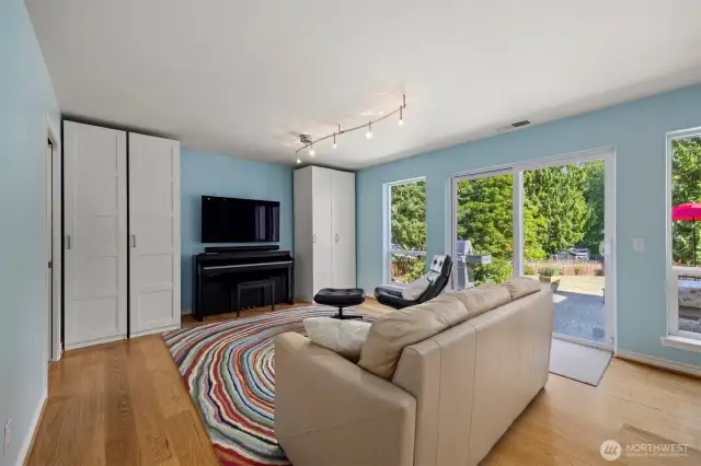 A few steps down from the foyer leads to another living space. Tons of light throughout the day. Sliding patio door to spacious patio