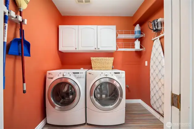 Laundry room features marmolium and ample storage.