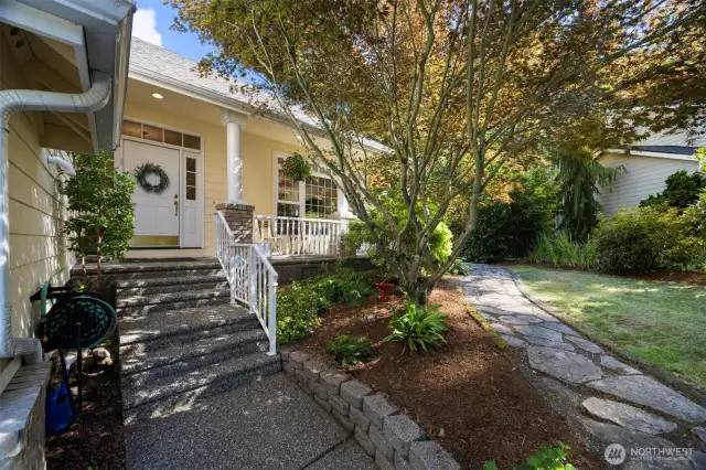 Well landscaped front entrace area with stone pathway to the back yard and stone path to the backyard