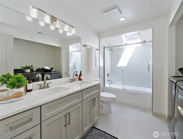 Main floor bathroom full size washer and dryer New cabinets, flooring, lighting, tub