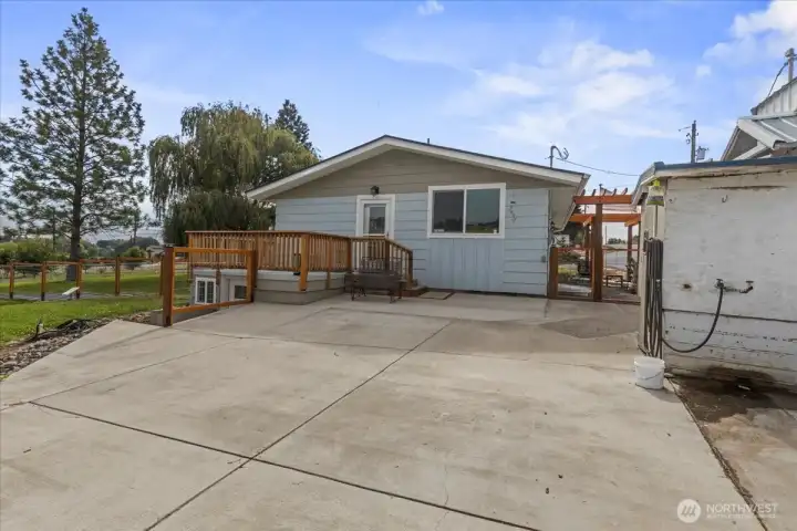 Back entry from private deck or lower level to mud room on the left. Huge patio area. structure to the right is new water treatment shed