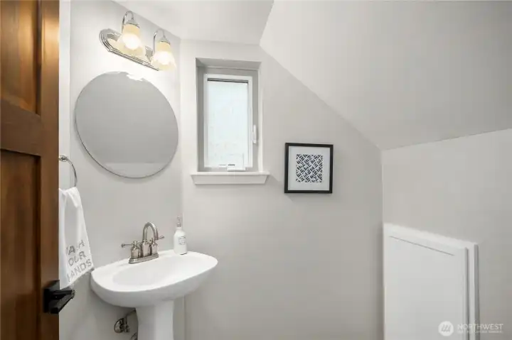 Downstairs powder room with under-stairs storage