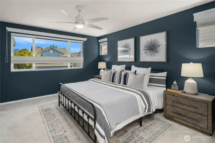 The spacious primary bedroom has views of the mountains and up/down blackout honeycomb blinds