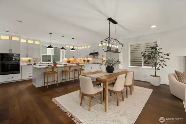 Dining Area: Open dining space seamlessly connects kitchen and great room, anchored by a modern statement chandelier and wide-plank hardwood floors. Large windows provide natural light, creating a warm and welcoming setting for gatherings in the heart of Bothell’s Canyon Park.    Photos are from THIS model home at Foxmoore but are for visualization purposes only.