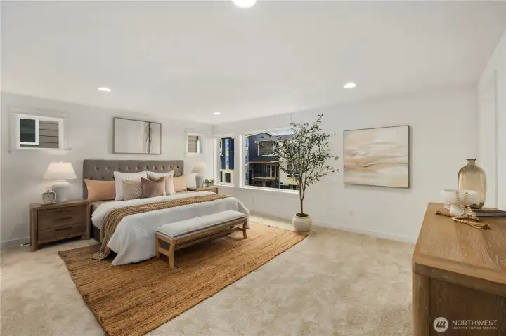 Primary Bedroom: Expansive primary suite offers plush carpeting, recessed lighting, and oversized windows that capture natural light and neighborhood views. The generous layout creates a serene retreat with space to unwind at the end of the day.    Photos are from THIS model home at Foxmoore but are for visualization purposes only.