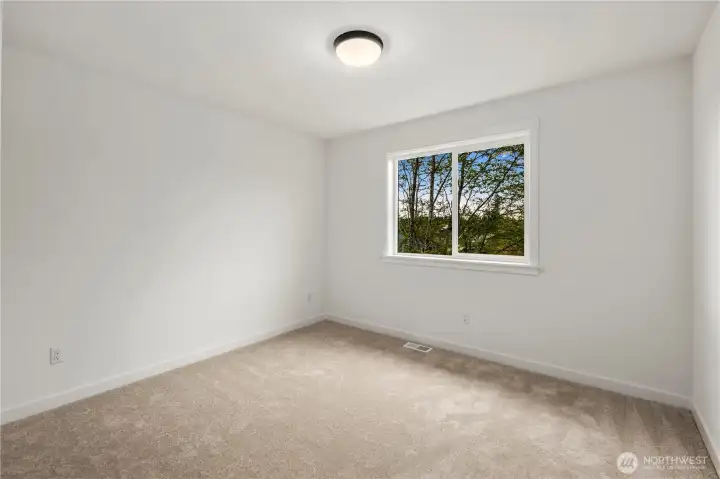 Additional Upper Level Bedroom: Bright secondary bedroom with neutral tones and plush carpet offers a versatile space ready for your needs. Large window brings in soft natural light, making it equally functional as a restful retreat or creative workspace.      Photos are from THIS model home at Foxmoore but are for visualization purposes only.
