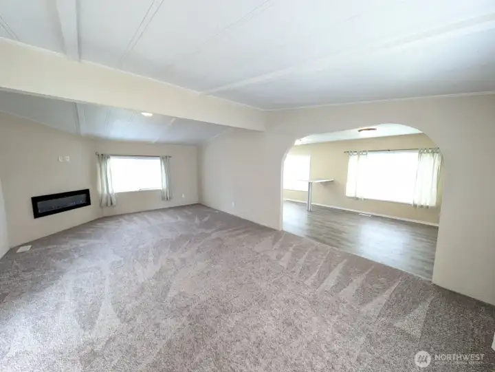 Vaulted family room w/new carpet & electric fireplace.