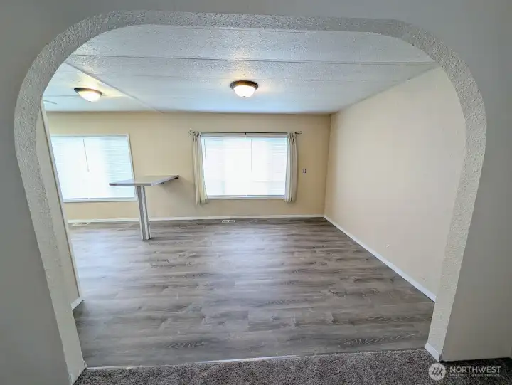 Arched doorway leads to the dining room & kitchen.
