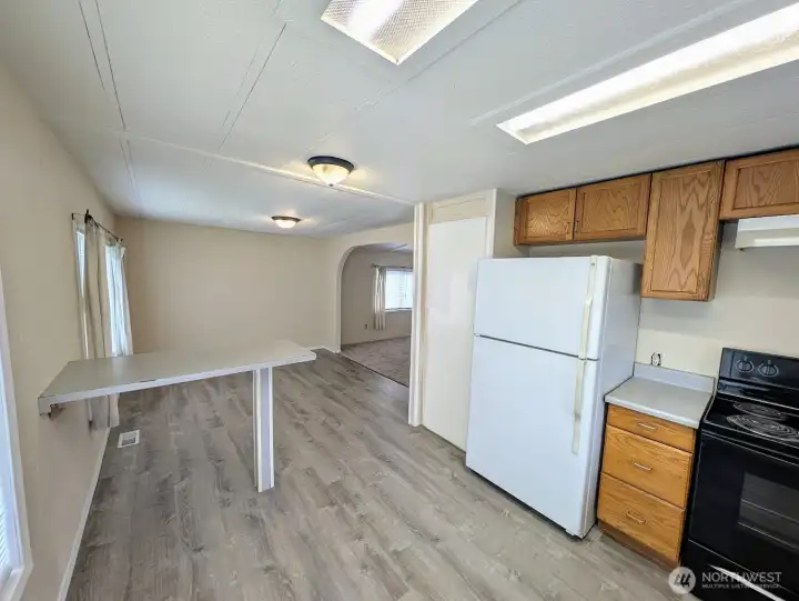 The kitchen with eating & dining areas open to the large family room.