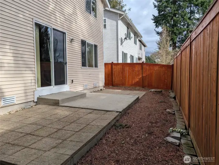 Sliders lead to backyard  patio and planting area